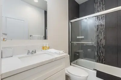 a bathroom with a sink and a toilet and a shower at Stylish DTLA Home With Views in Los Angeles
