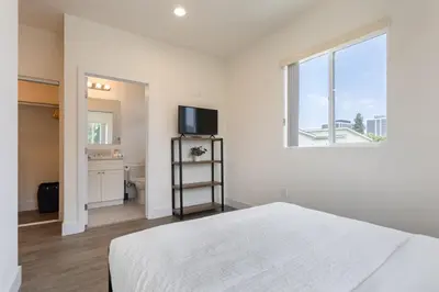 a white bedroom with a bed and a window at Stylish DTLA Home With Views in Los Angeles