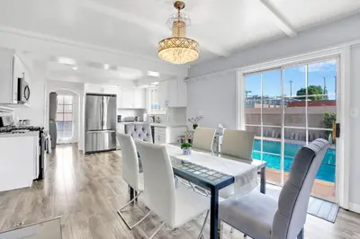 a kitchen and dining room with a table and chairs at Valley Ranch With Pool in Los Angeles