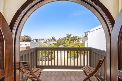 two chairs on a balcony with a view of the ocean at Venice Beach Villa in Los Angeles