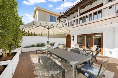 a patio with a table and chairs and an umbrella at Venice Beach Villa in Los Angeles