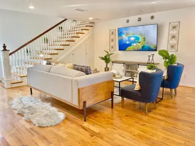 a living room with a couch and a table at New Charming Spacious Disneyland Pool Home in Garden Grove