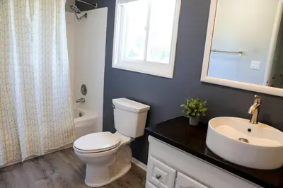 a bathroom with a toilet and a sink and a mirror at GREAT VIEWS - Over the Oaks - Stylish - Whole Home in Thousand Oaks