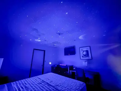 a bedroom with a starry ceiling and a bed at Super 7 Motel - Anaheim Packing District & Disneyland in Anaheim