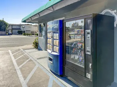 a pepsi machine sitting outside of a gas station at Super 7 Motel - Anaheim Packing District & Disneyland in Anaheim