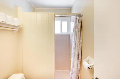 a bathroom with a shower and a toilet at 2 Mi to Ocean Long Beach Home with Gas Grill! in Long Beach