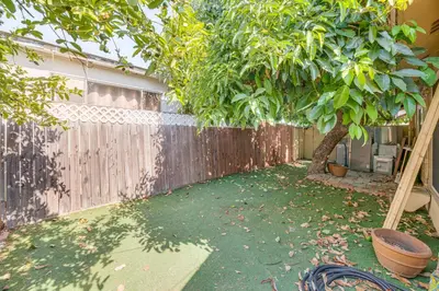 a backyard with a fence and a tree at Walk to Dtwn Shops! Extended Stay Home in Burbank in Burbank