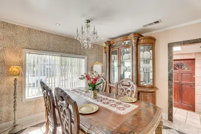 a dining room with a table and chairs and a chandelier at Walk to Dtwn Shops! Extended Stay Home in Burbank in Burbank