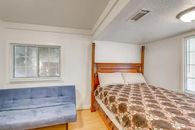 a bedroom with a bed and a blue couch at Walk to Dtwn Shops! Extended Stay Home in Burbank in Burbank