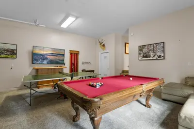 a room with a pool table and two tables at Arctic Wolf at Summit Base - 4 Bedroom log cabin at the base of Snow Summit in Big Bear Lake