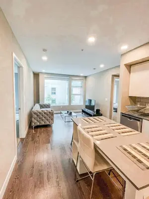 a kitchen and living room with a table and a couch at Glamorous Getaway in Hollywood in Los Angeles