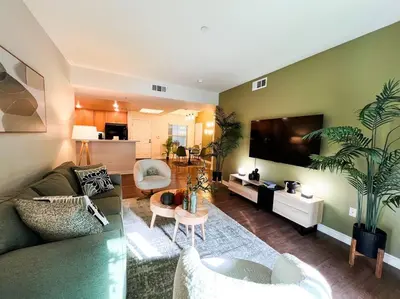 a living room with a couch and a flat screen tv at Cozy Apartment in Heart of Encino 104 in Encino