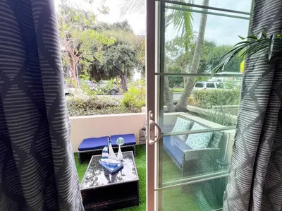 a sliding glass door to a patio with a table at Cozy Apartment in Heart of Encino 104 in Encino