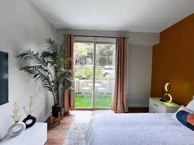 a bedroom with a bed and a large window at Cozy Apartment in Heart of Encino 104 in Encino