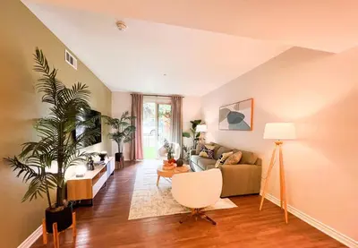 a living room with a couch and a chair at Cozy Apartment in Heart of Encino 104 in Encino