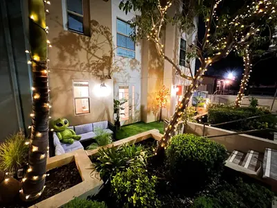 a teddy bear sitting on a couch in a garden with lights at Beautiful 2 BD 3 Beds in Heart of Encino 105 in Encino