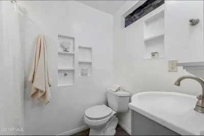 a white bathroom with a toilet and a sink at Emeric Ave in Simi Valley in Simi Valley