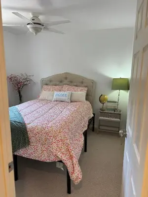a bedroom with a bed with a flowered comforter at Emeric Ave in Simi Valley in Simi Valley