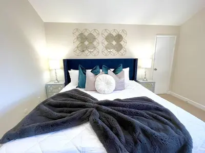 a bedroom with a large bed with a blanket on it at Family Paradise near Disneyland with Sparkling Pool in Del Prado Bolsa