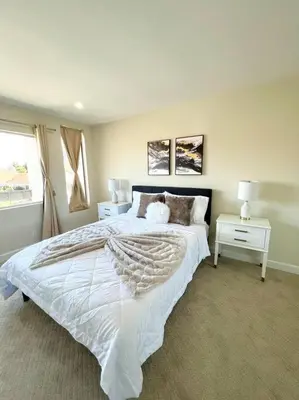 a bedroom with a large white bed and a window at Family Paradise near Disneyland with Sparkling Pool in Del Prado Bolsa