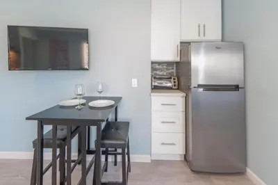 a kitchen with a table and a refrigerator at Sunny Studio in the Heart of Venice Beach - #6 in Los Angeles