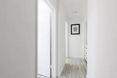 a hallway with white walls and a large mirror at Sunny 1 Bedroom in the Heart of Venice Beach - #1 in Los Angeles
