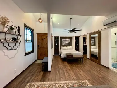 a bedroom with a bed and a ceiling fan at Cozy Guesthouse with Rooftop Deck in Los Angeles