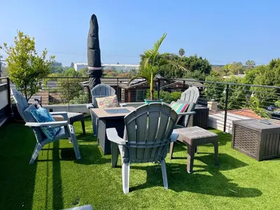 a group of chairs and a table on a patio at Cozy Guesthouse with Rooftop Deck in Los Angeles