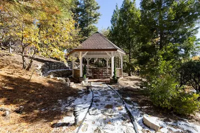 a gazebo in the middle of a field at Gingerbread Gardens in Twin Peaks