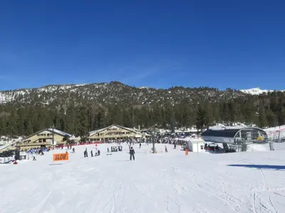 a group of people skiing on a snow covered slope at Hideaway at Gingerbread Gardens in Twin Peaks