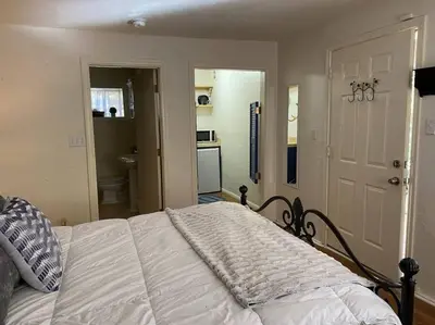 a bedroom with a bed and a bathroom at Hideaway at Gingerbread Gardens in Twin Peaks