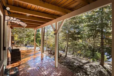 an open porch of a house with a view of trees at Hideaway at Gingerbread Gardens in Twin Peaks
