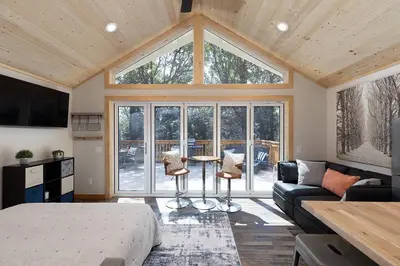 a bedroom with a bed and a large window at One With Nature in Crest Park