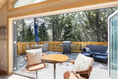 a screened in porch with a table and chairs at One With Nature in Crest Park