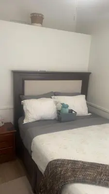 a bed with a headboard with a stuffed animal on it at Oasis Home near Rancho Vista in Quartz Hill