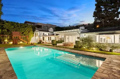 a swimming pool in front of a house at Belmont Beverly Hills by Stay Awhile Villas in Los Angeles