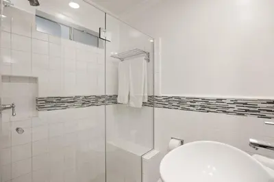 a bathroom with a shower and a toilet and a sink at Belmont Beverly Hills by Stay Awhile Villas in Los Angeles