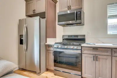 a kitchen with a stainless steel refrigerator and a microwave at 10 Mi to Dtwn LA Cat-Friendly Rosemead Cottage in Rosemead