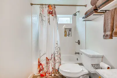 a bathroom with a toilet and a shower curtain at 10 Mi to Dtwn LA Cat-Friendly Rosemead Cottage in Rosemead