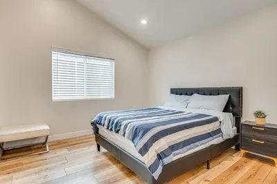 a white bedroom with a bed and a window at 10 Mi to Dtwn LA Cat-Friendly Rosemead Cottage in Rosemead