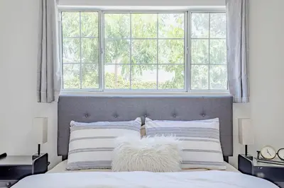 a bedroom with a bed with a large window at Cozy Home with Pool and Jacuzzi Minutes from Universal Studios in Los Angeles