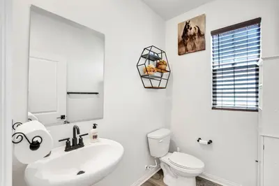 a white bathroom with a sink and a toilet at Charming Home Near Six Flags in Santa Clarita