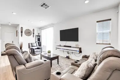 a living room with two couches and a flat screen tv at Charming Home Near Six Flags in Santa Clarita