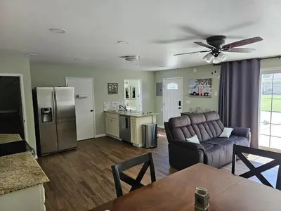 a living room with a couch and a kitchen at Spacious 2 story 1 bedroom home with pool in Rio Bravo