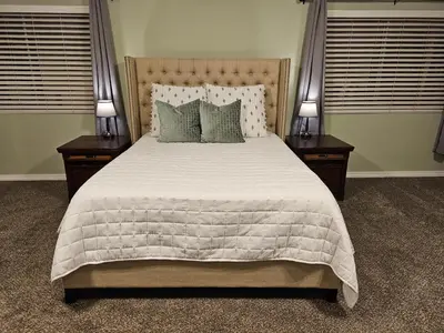 a bedroom with a large bed with two night stands at Spacious 2 story 1 bedroom home with pool in Rio Bravo