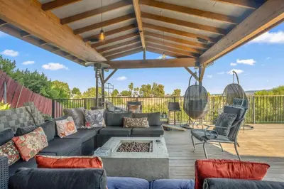 a patio with a couch and chairs on a deck at Middlebury Heights with Pool in Los Angeles