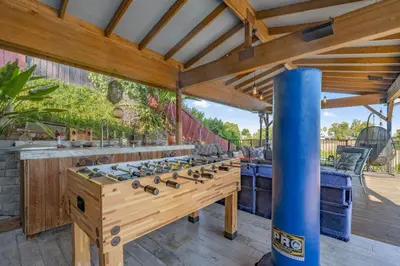 a large outdoor entertaining area with a large wooden game table at Middlebury Heights with Pool in Los Angeles