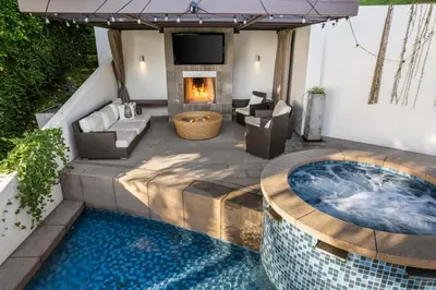 a patio with a hot tub and a fireplace at West Hollywood Hills Jacuzzi and Beautiful View in Los Angeles