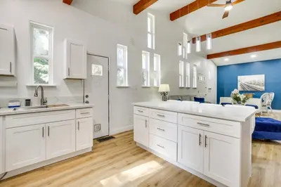 a bathroom with white cabinets and blue walls at Lake Arrowhead Hideaway with Deck and Hot Tub in Lake Arrowhead