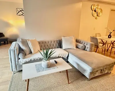 a living room with a couch and a table at Hollywood Luxury Retreat I Pool Views I Jacuzzi I Fitness Center I Free Parking! in Los Angeles